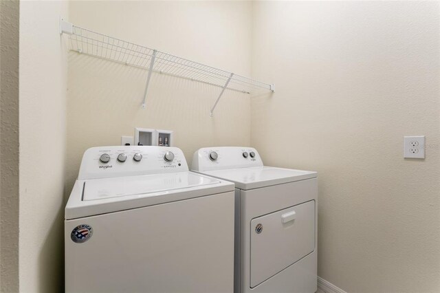 washroom with washer hookup and washer and clothes dryer