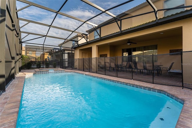 view of pool with a lanai, ceiling fan, and a patio area