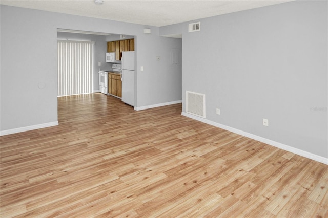 unfurnished living room featuring light wood-type flooring