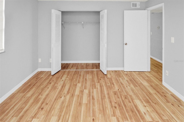 unfurnished bedroom featuring a closet and light wood-type flooring