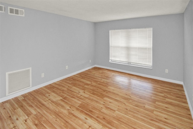 empty room with light hardwood / wood-style floors