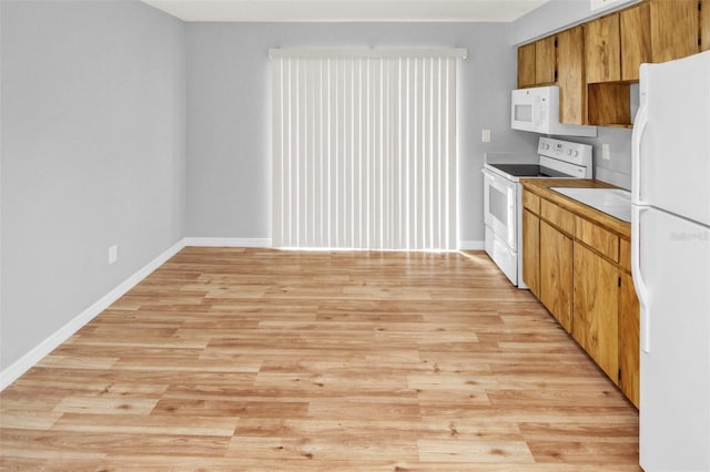 kitchen featuring white appliances and light wood-type flooring