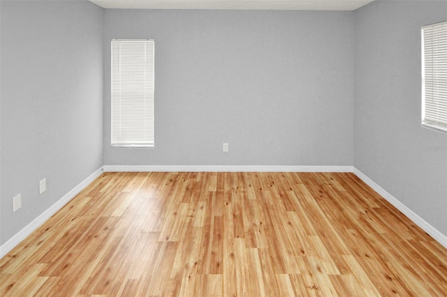 spare room with wood-type flooring