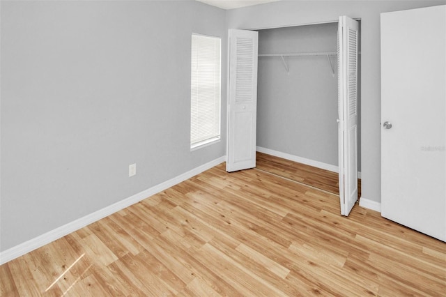 unfurnished bedroom with light hardwood / wood-style floors and a closet