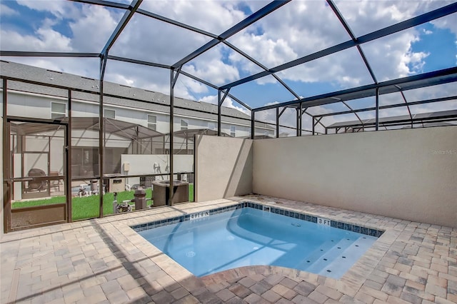 view of swimming pool with a patio and a lanai