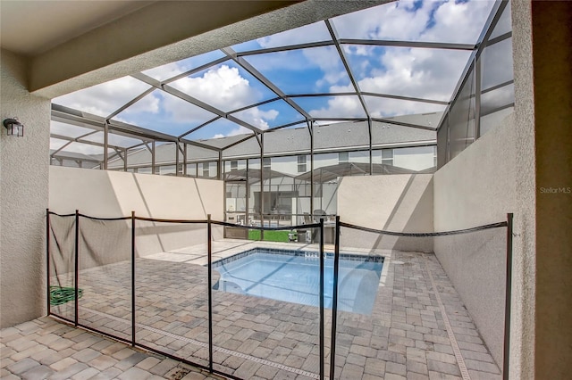 view of pool with a patio and a lanai