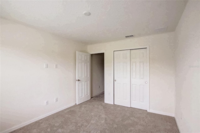 unfurnished bedroom with a closet and carpet