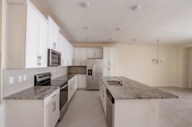 kitchen with white cabinetry, a kitchen island with sink, sink, pendant lighting, and stainless steel appliances