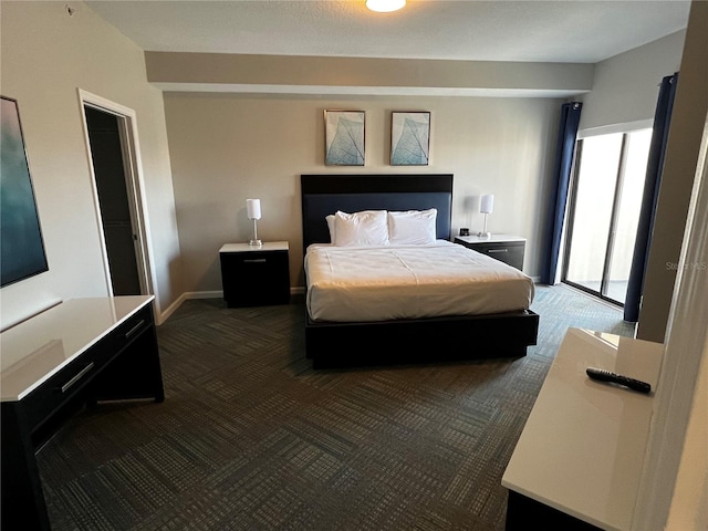 bedroom with dark colored carpet