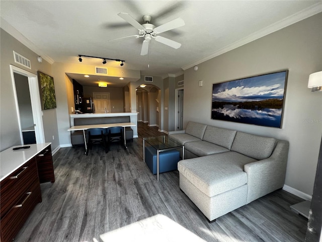 living room with rail lighting, dark hardwood / wood-style floors, ceiling fan, and crown molding