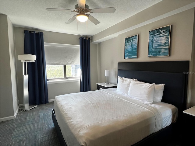 carpeted bedroom with ceiling fan and a textured ceiling