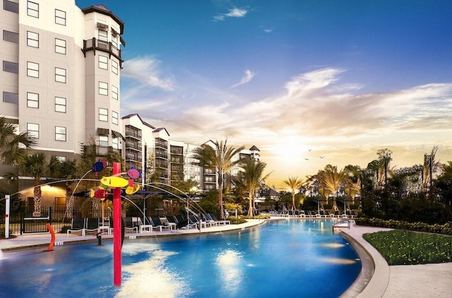 pool at dusk featuring a patio