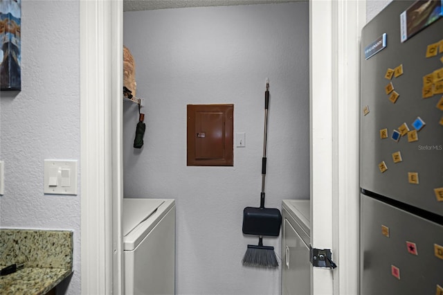 laundry room with a textured ceiling and separate washer and dryer