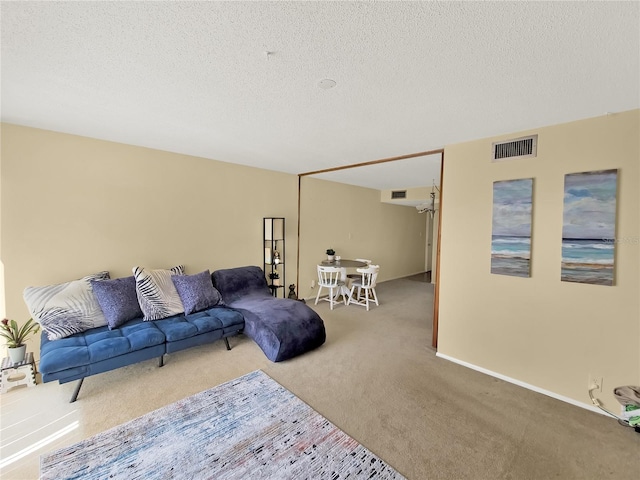 living room with light carpet and a textured ceiling