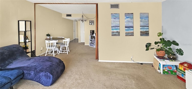 living room with light colored carpet and a chandelier