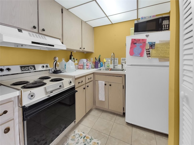 kitchen with white appliances, sink, and light tile floors