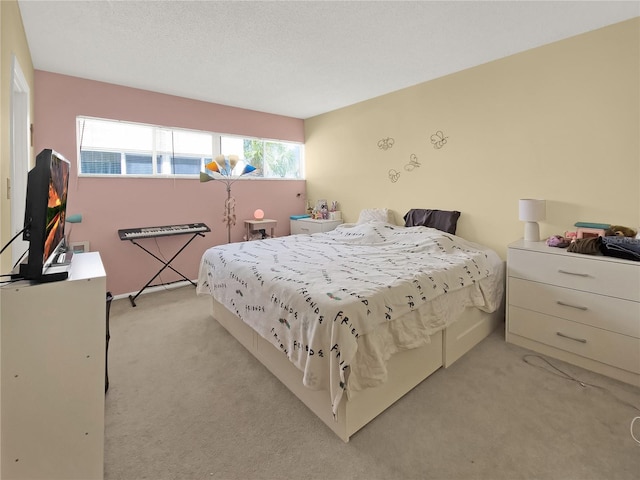 bedroom featuring a textured ceiling, light colored carpet, and multiple windows