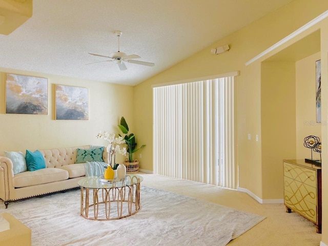 carpeted living room featuring a textured ceiling, ceiling fan, and vaulted ceiling