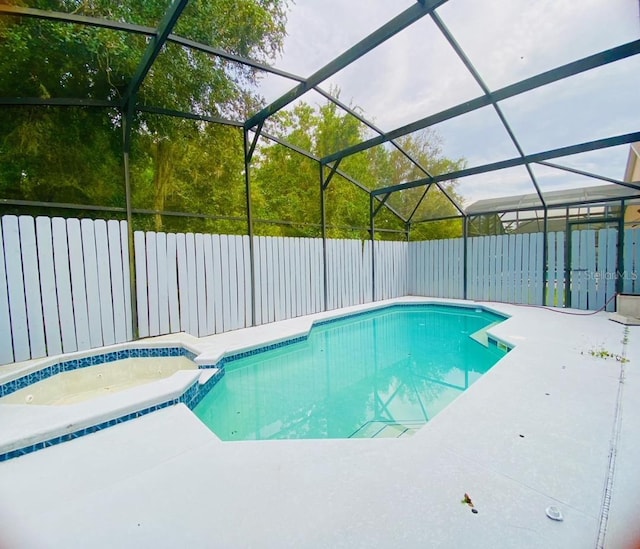 view of swimming pool with a patio and glass enclosure