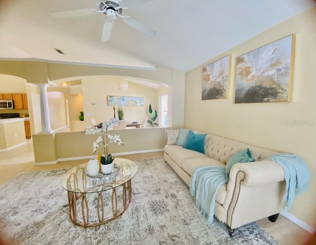 carpeted living room with lofted ceiling, ceiling fan, and decorative columns