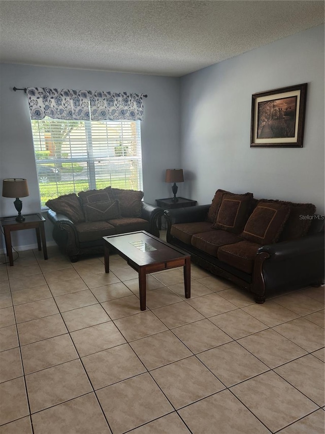 living room featuring light tile patterned floors and a textured ceiling