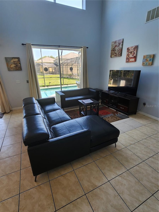 tiled living room with a high ceiling