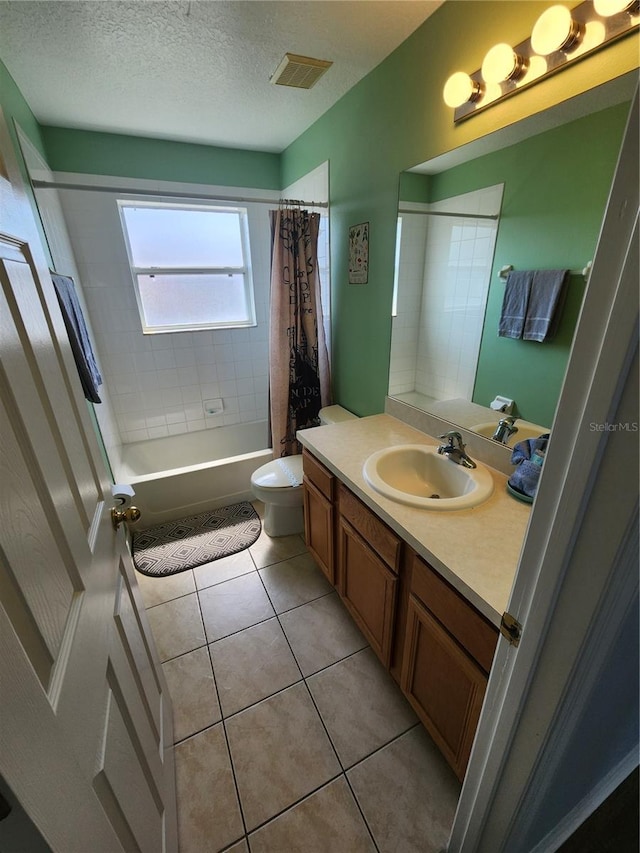 full bathroom featuring tile patterned floors, a textured ceiling, toilet, shower / tub combo with curtain, and vanity