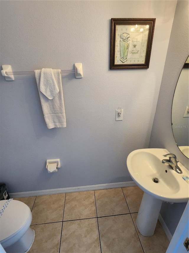 bathroom with tile patterned floors and toilet