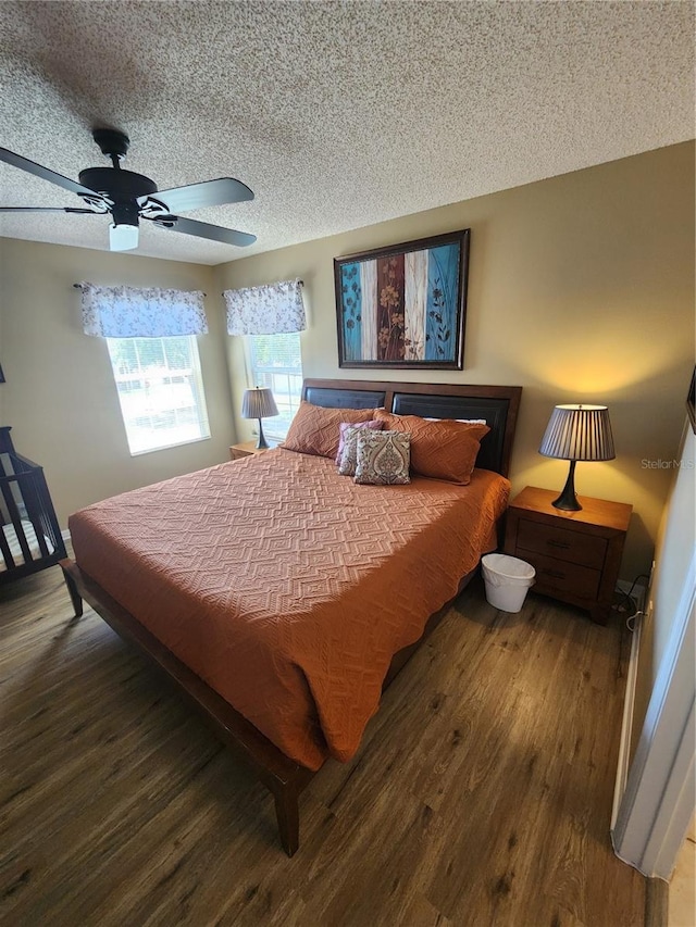 bedroom with hardwood / wood-style floors, a textured ceiling, and ceiling fan