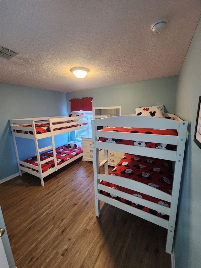 bedroom featuring a textured ceiling and hardwood / wood-style flooring