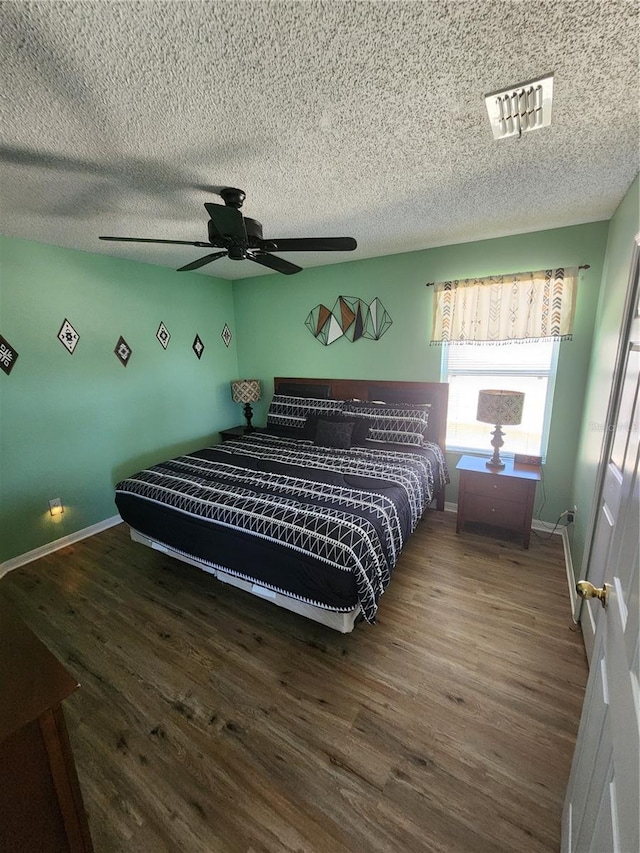 bedroom featuring ceiling fan and dark hardwood / wood-style floors