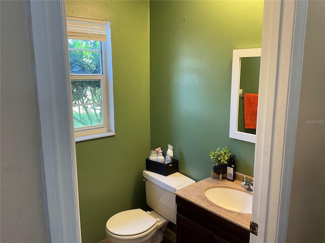 bathroom featuring toilet and vanity