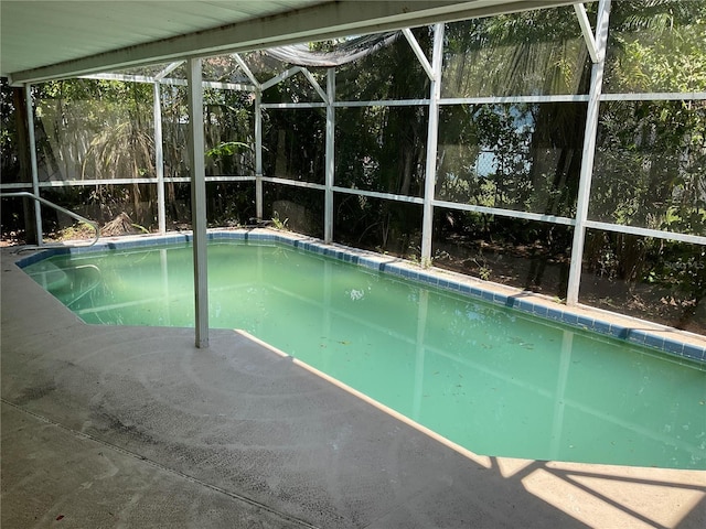 view of pool featuring glass enclosure