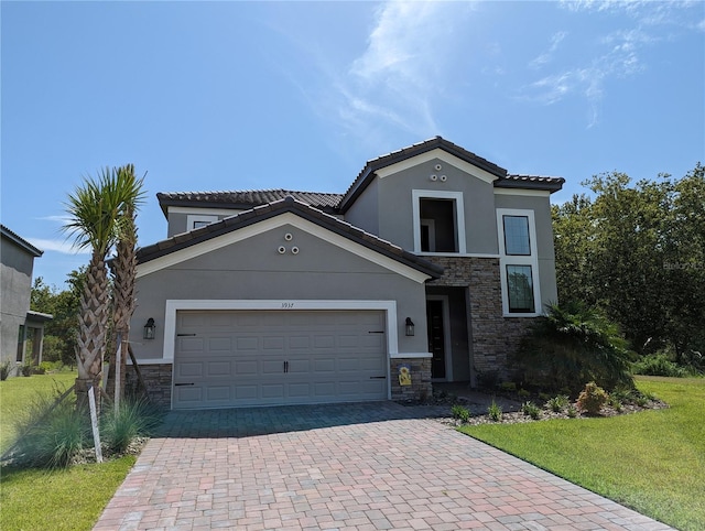 view of front of property featuring a front lawn and a garage