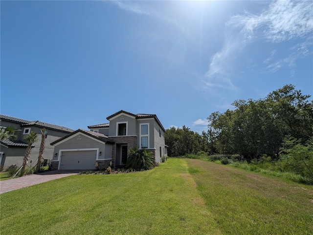 view of front of property with a garage and a front yard