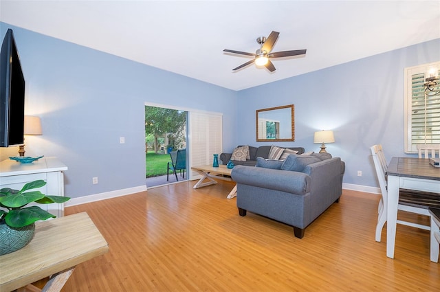 living room featuring ceiling fan and light wood-type flooring