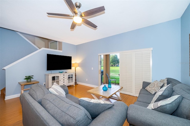 living room with light hardwood / wood-style floors and ceiling fan