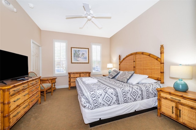 bedroom featuring dark colored carpet, ceiling fan, and vaulted ceiling