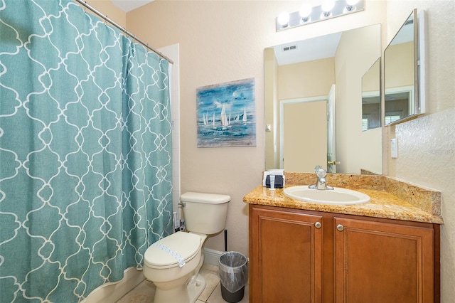 bathroom with toilet, tile flooring, and vanity