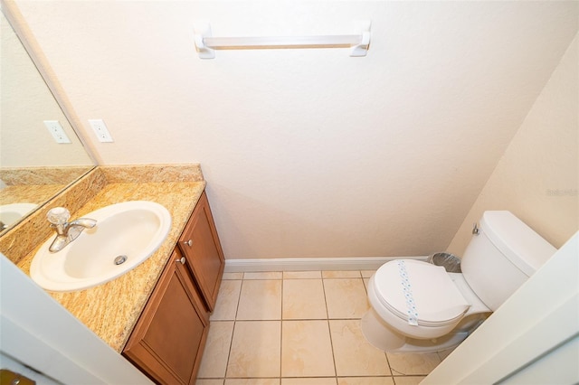 bathroom featuring vanity, tile floors, and toilet