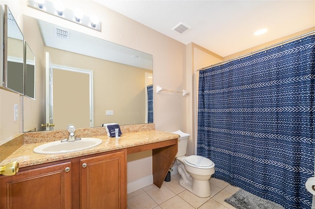 bathroom featuring toilet, tile flooring, and vanity