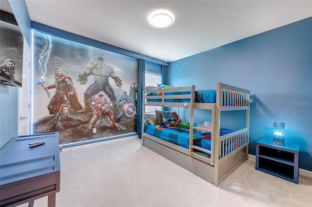 bedroom with a textured ceiling and carpet flooring