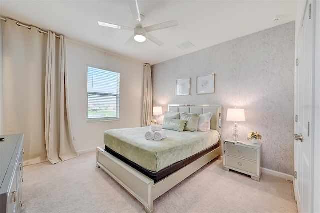 bedroom with ceiling fan and light carpet