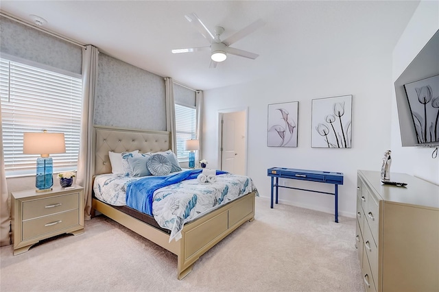 carpeted bedroom with ceiling fan and ensuite bath