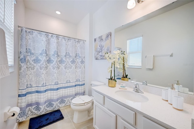 bathroom with toilet, tile patterned floors, and vanity