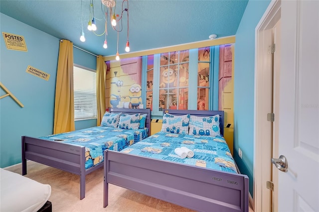 bedroom featuring an inviting chandelier, carpet floors, and a textured ceiling