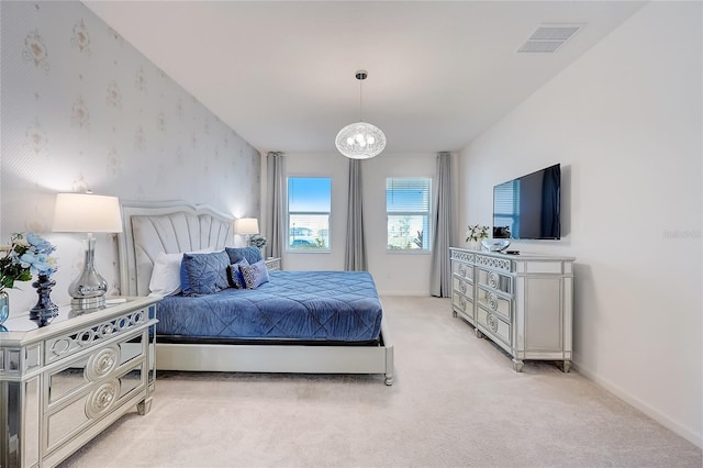 carpeted bedroom featuring a notable chandelier