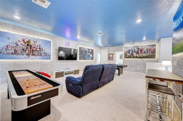 cinema room featuring brick wall, a textured ceiling, and carpet floors