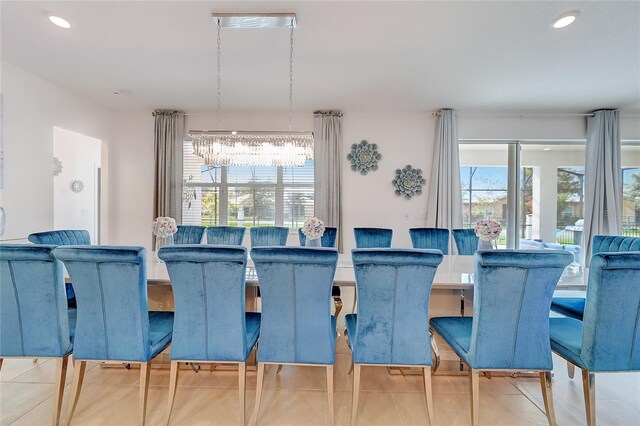 dining space with tile patterned flooring and a chandelier