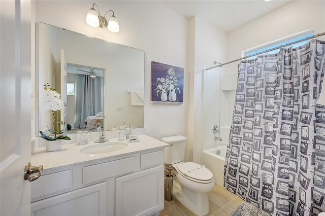 full bathroom featuring tile patterned flooring, toilet, shower / bath combo with shower curtain, vanity, and a healthy amount of sunlight